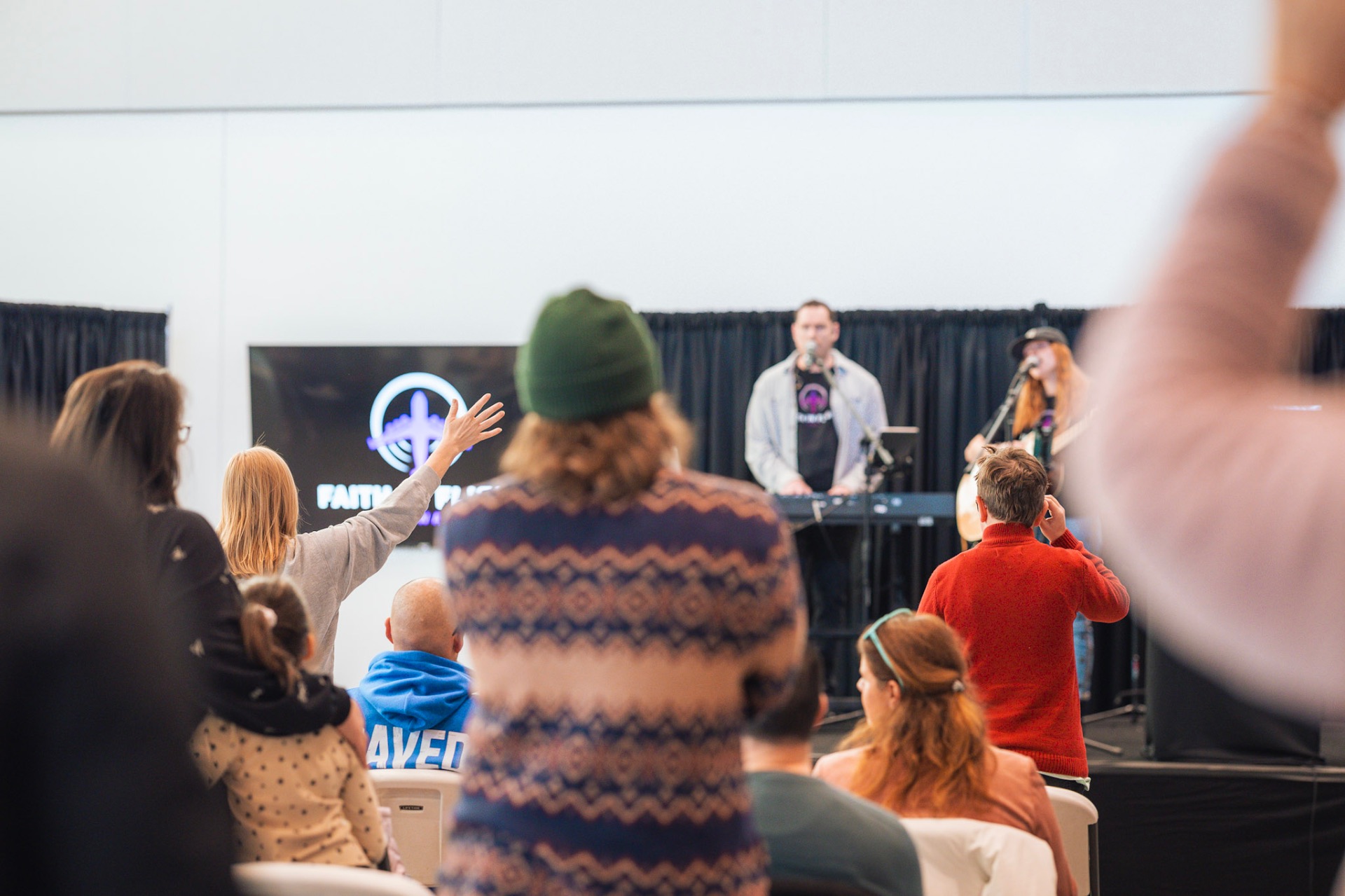 Worship with hands raised during Faith In Flight event
