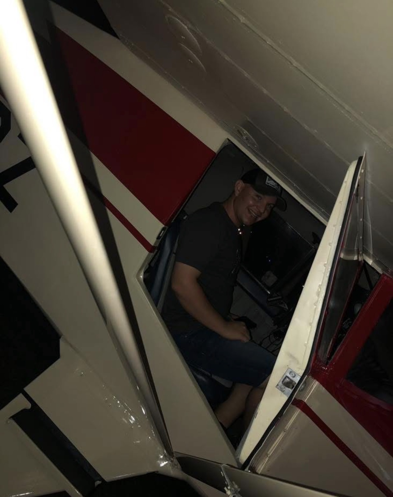 Volunteer smiling inside a red and white aircraft