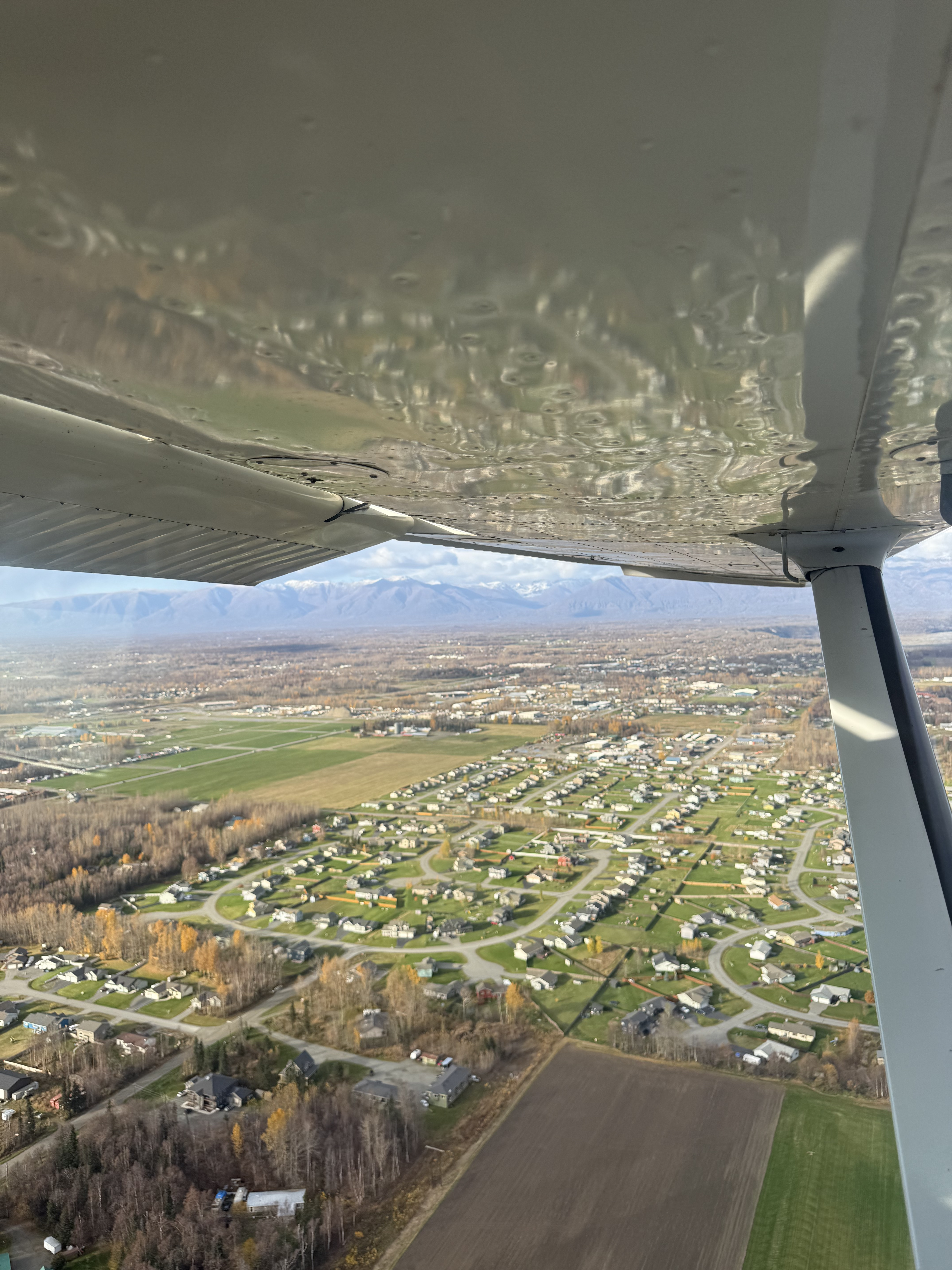 In-flight view of a small aircraft over a scenic landscape